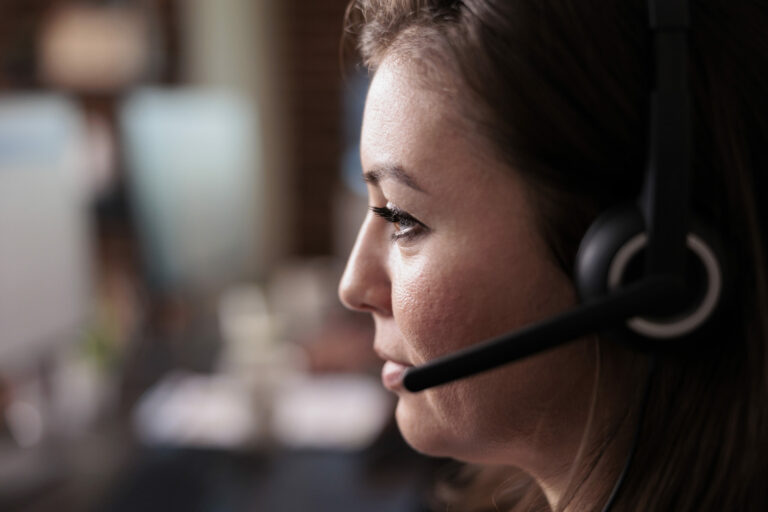 Female receptionist wearing headphones to work at call center