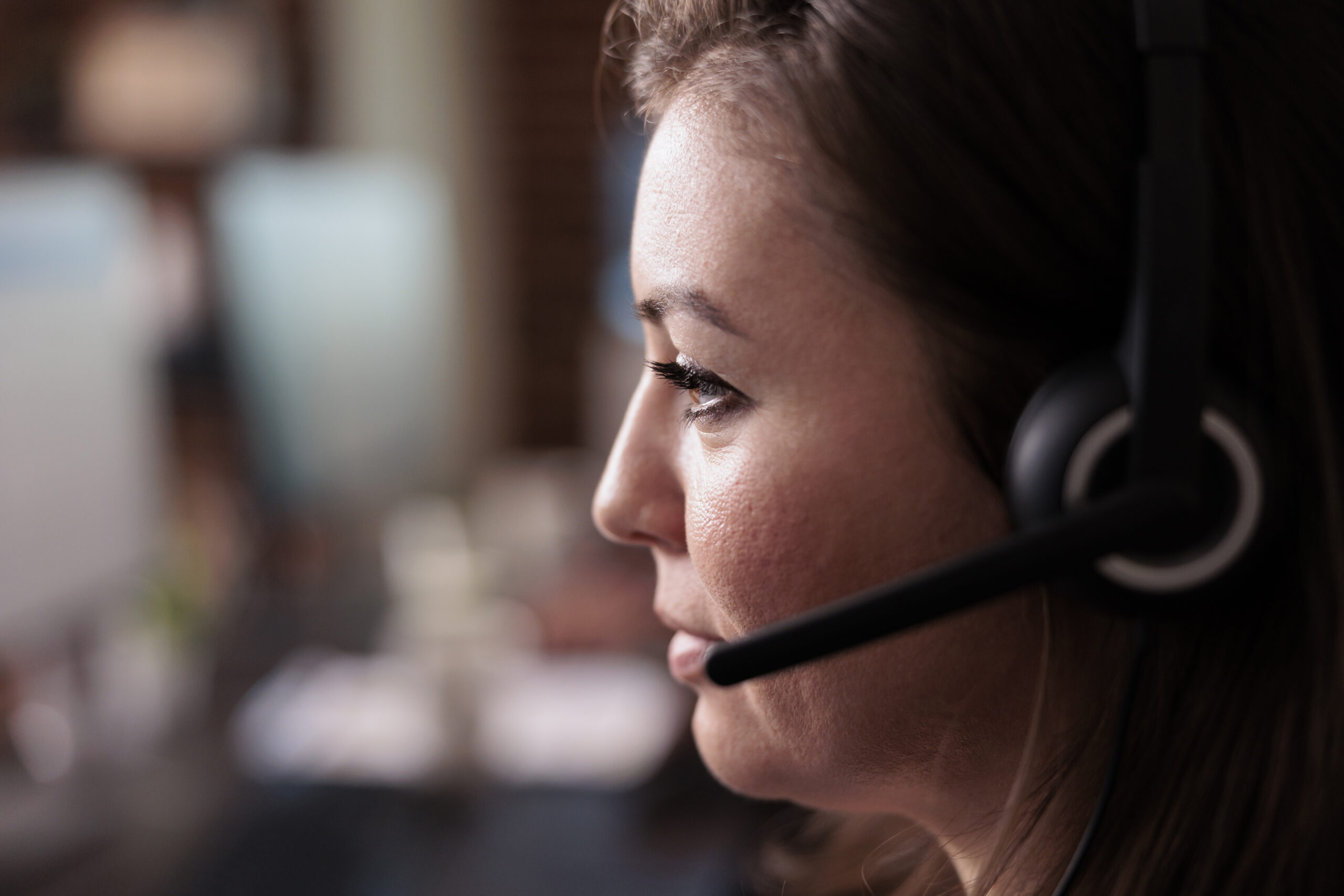 Female receptionist wearing headphones to work at call center